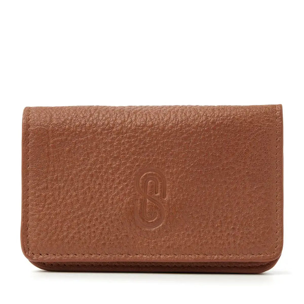 Leather insulin pump holder with a sealable flap and magnetic closure for diabetes management.