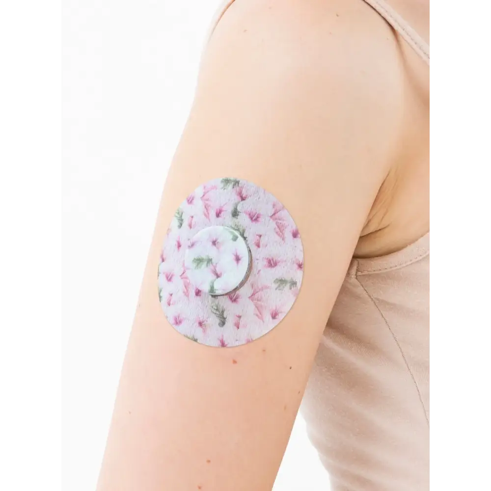 FreeStyle Libre 2 adhesive patch, Spring Series, on the arm with its decorative centre piece