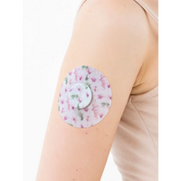 FreeStyle Libre 2 adhesive patch, Spring Series, on the arm with its decorative centre piece