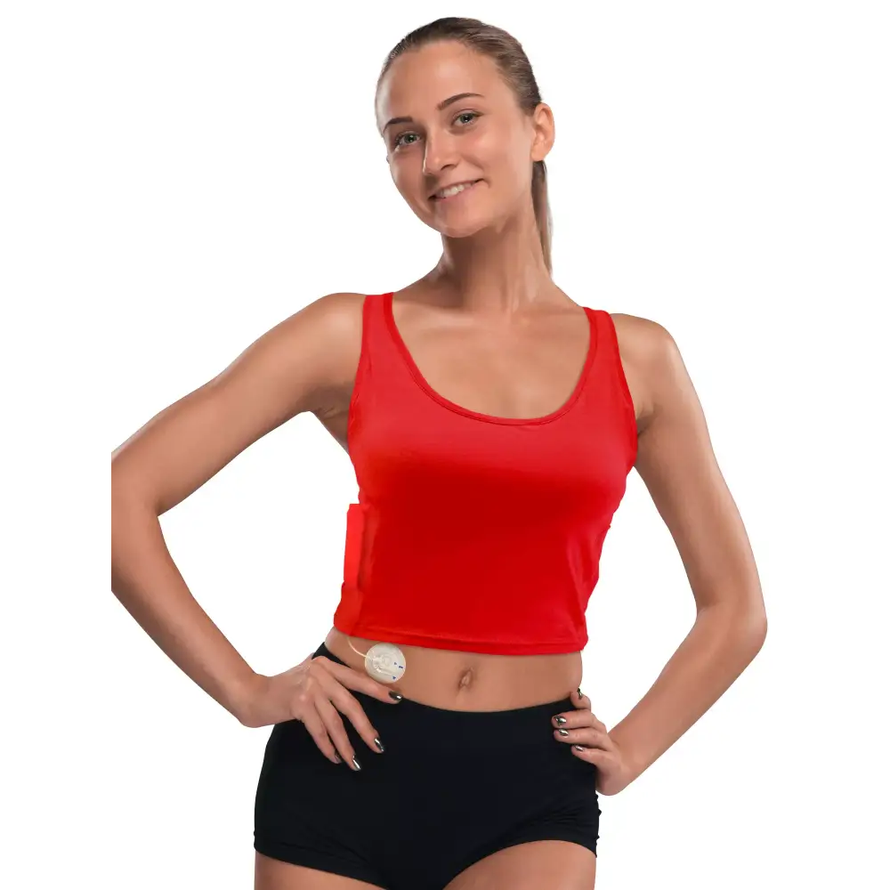 Woman wearing a red crop top designed for insulin pumps with integrated pockets.