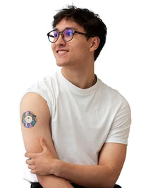 FreeStyle Libre 3 adhesive patch, Lucid Echo design, worn on the arm by a man