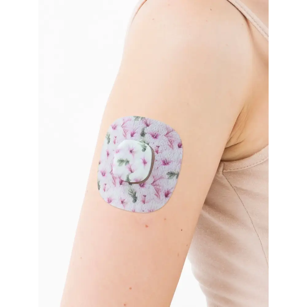 Simplera Sync adhesive patch, Spring Series, on the arm with its decorative centre piece
