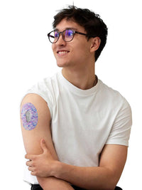 Dexcom G6 adhesive patch, Spring Series, worn on the arm by a man