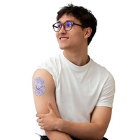 Dexcom G7 adhesive patch, Spring Series, worn on the arm by a man