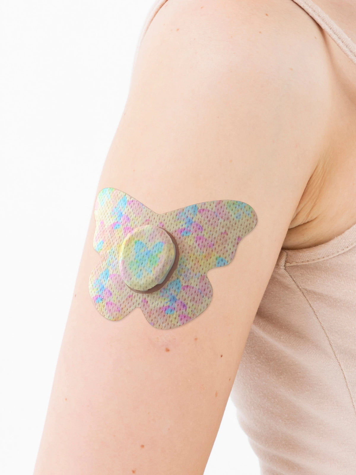 Dexcom G7 adhesive patch, butterfly shape, on the arm, close-up