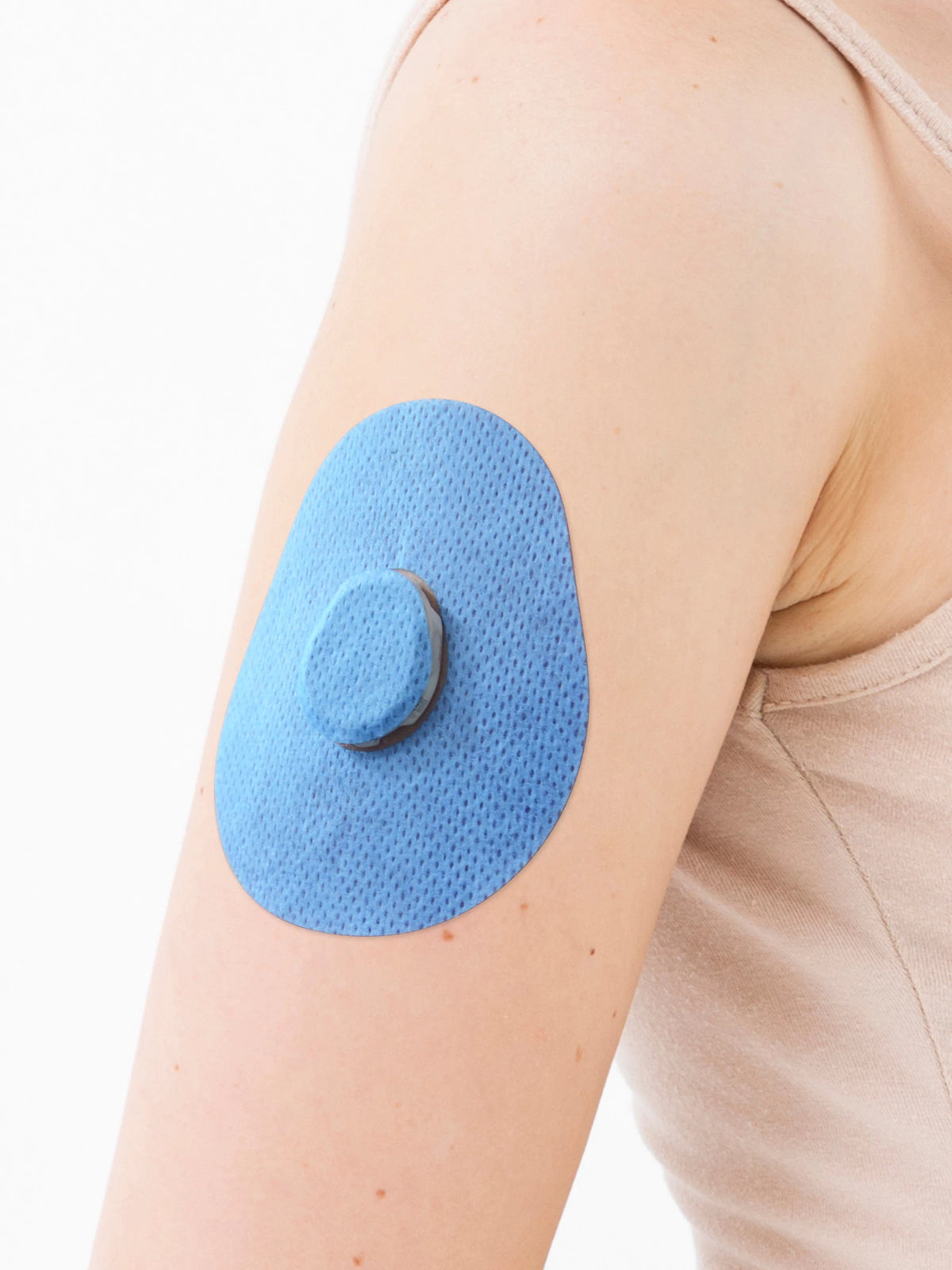 Dexcom G7 adhesive patch, drop shape, on the arm, close-up
