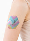 Dexcom G7 hexagonal shape patch close-up on arm, showing breathable adhesive support around the sensor