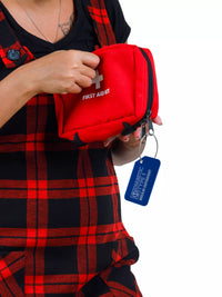 Person holding a red first aid kit with a blue 'Diabetic Type 1 Insulin Dependent' luggage tag attached.