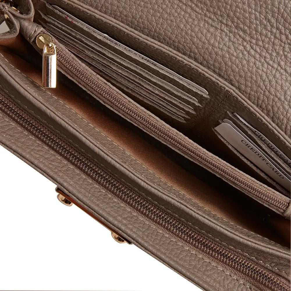 Close-up of taupe leather diabetic shoulder bag interior showing zippered compartments and card slots