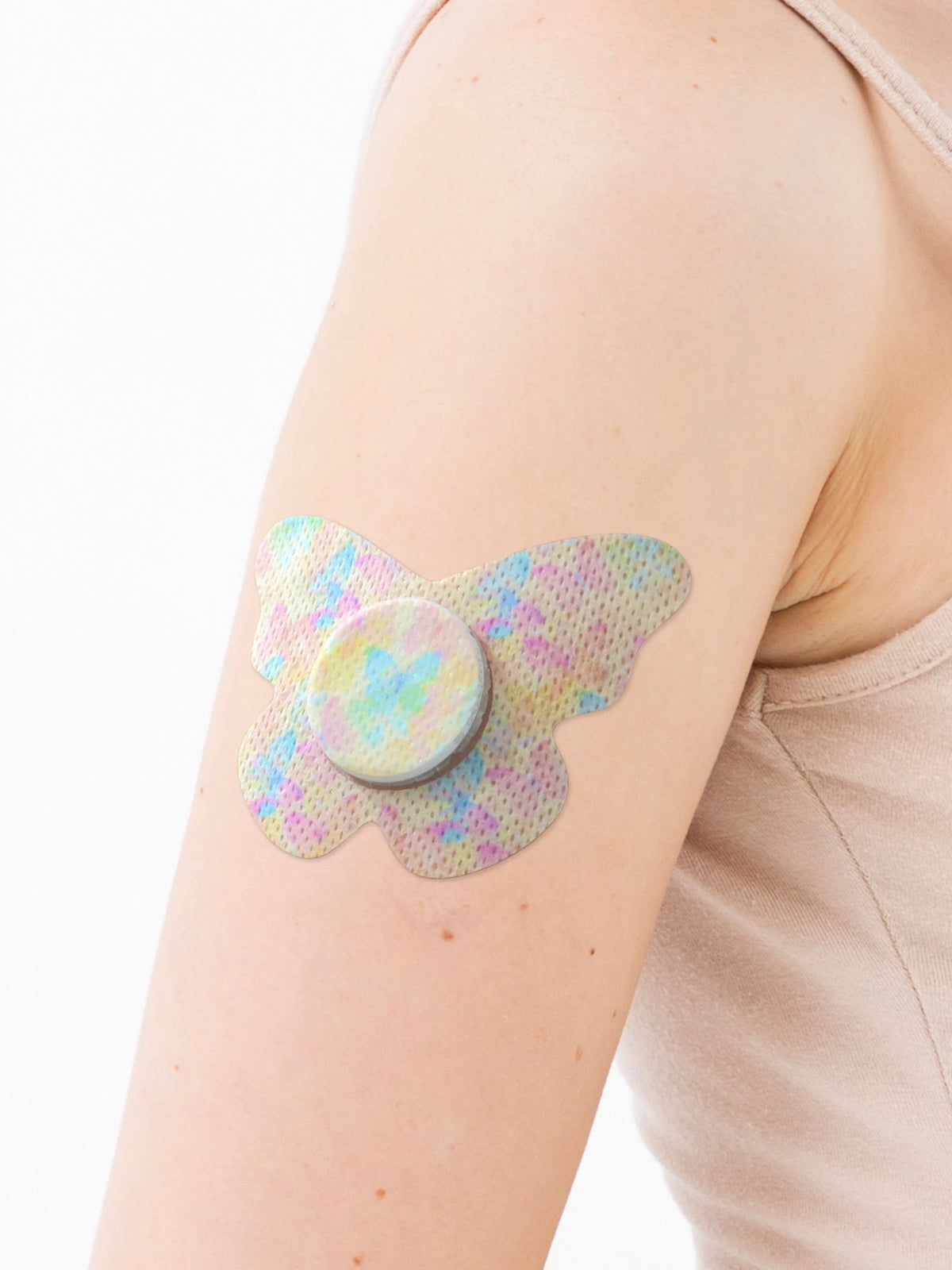 FreeStyle Libre 2 adhesive patch, butterfly shape, on the arm, close-up