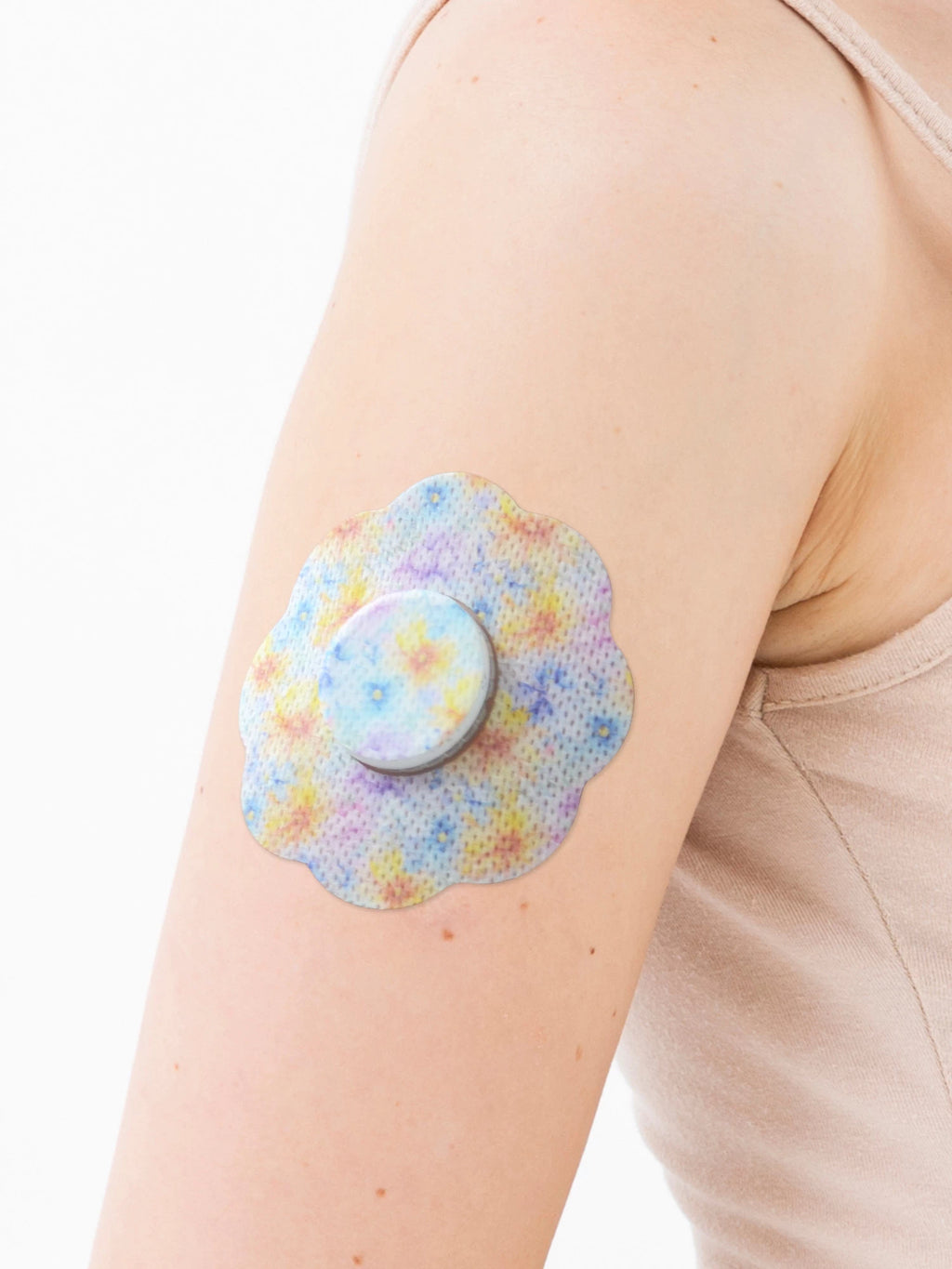 FreeStyle Libre 2 adhesive patch, cookie shape, on the arm, close-up