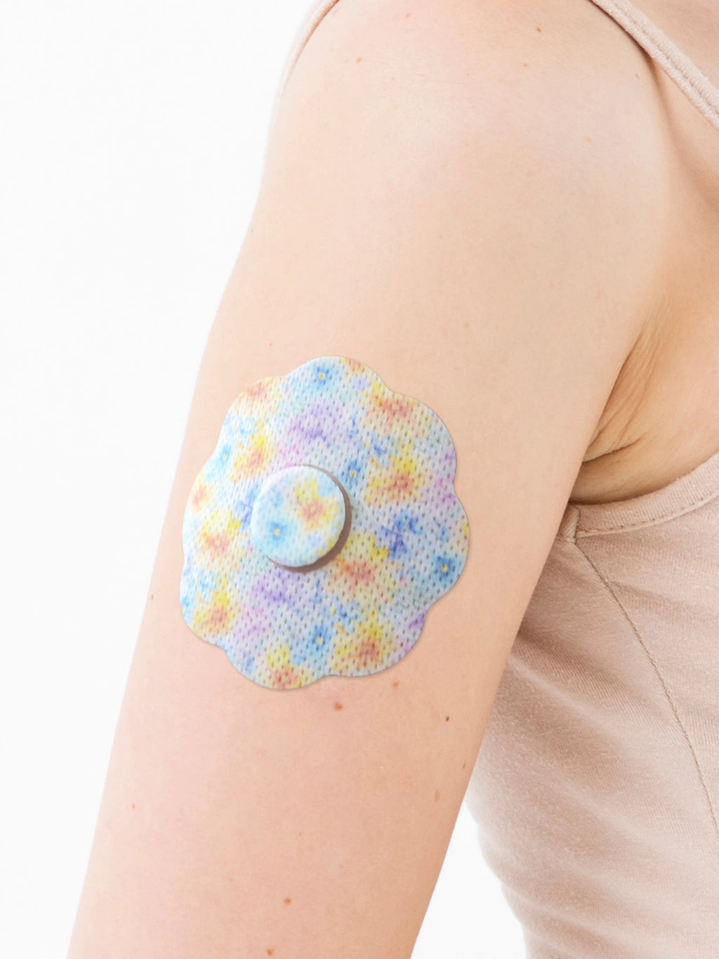 FreeStyle Libre 3 adhesive patch, cookie shape, on the arm, close-up