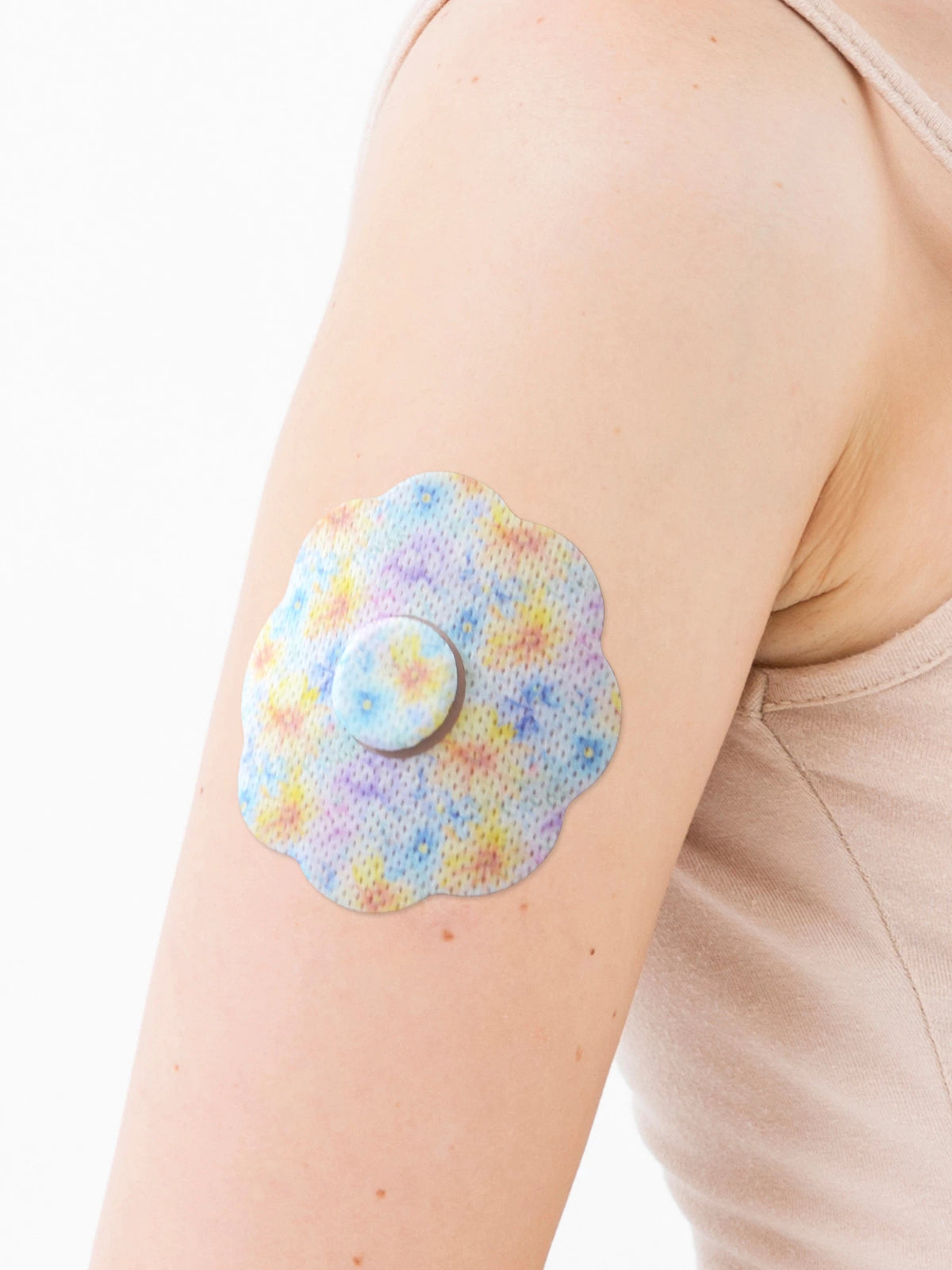 FreeStyle Libre 3 cookie shape patch close-up on arm, showing breathable adhesive support around the sensor