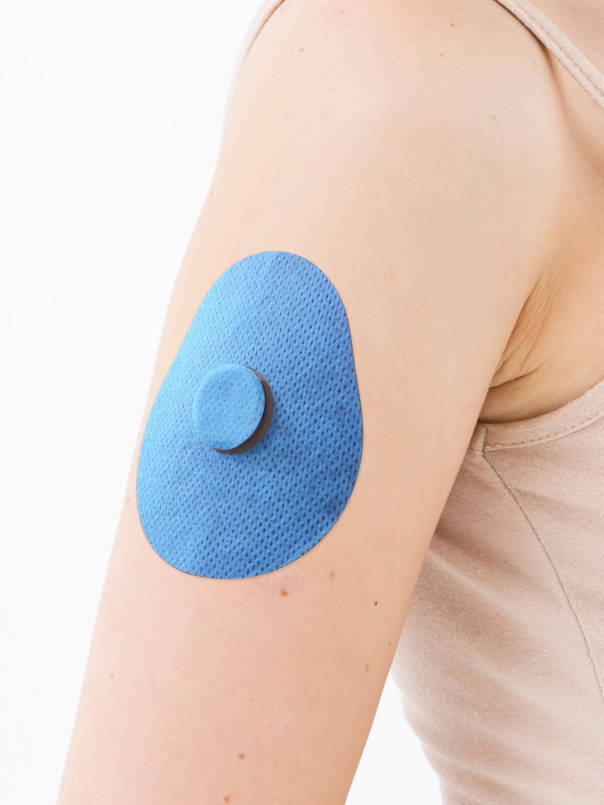 FreeStyle Libre 3 adhesive patch, drop shape, on the arm, close-up