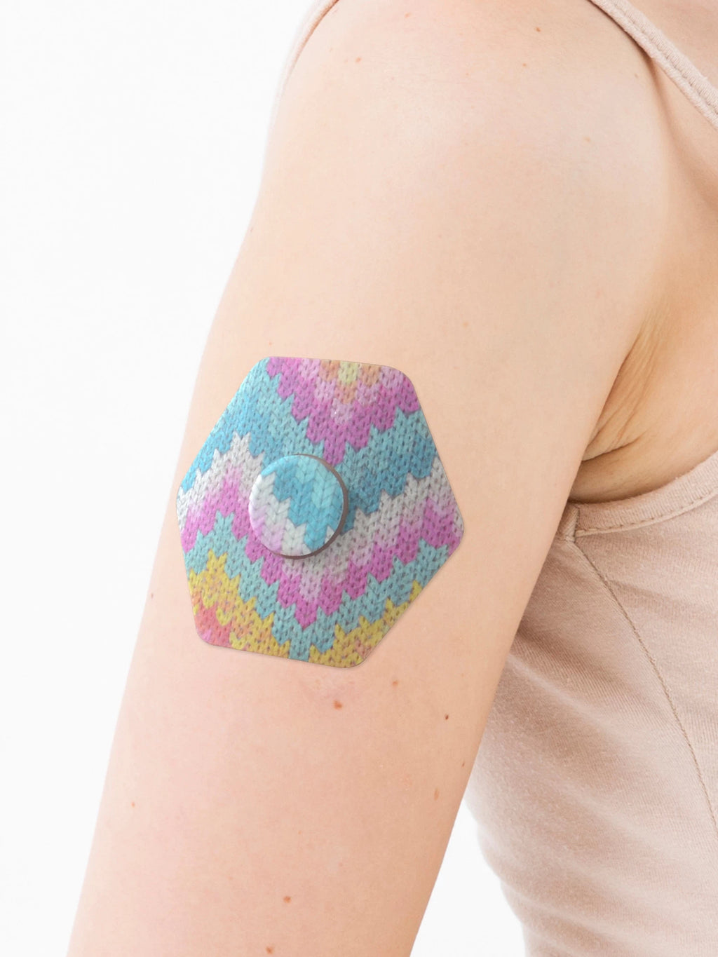 FreeStyle Libre 3 adhesive patch, hexagonal shape, on the arm, close-up