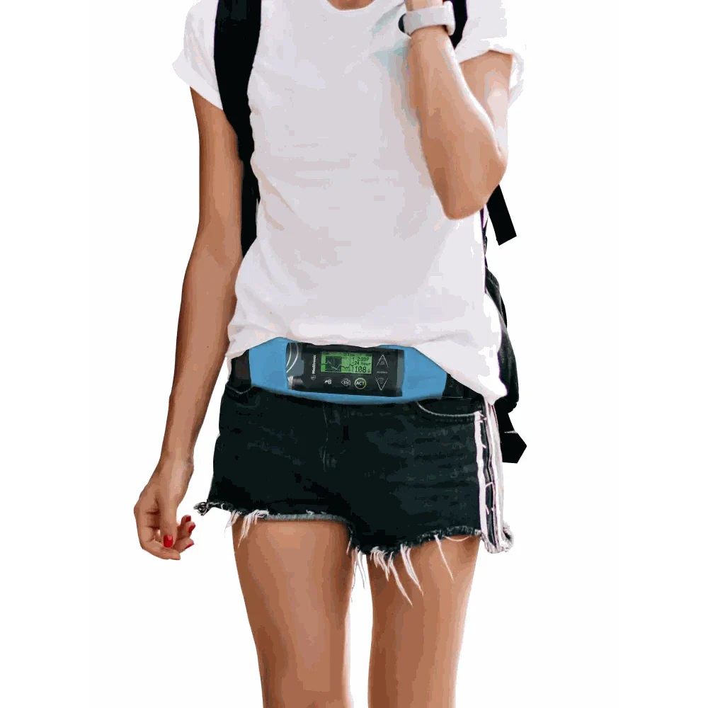 Insulin pump belt with transparent window for accessible monitoring, worn by person in casual attire.