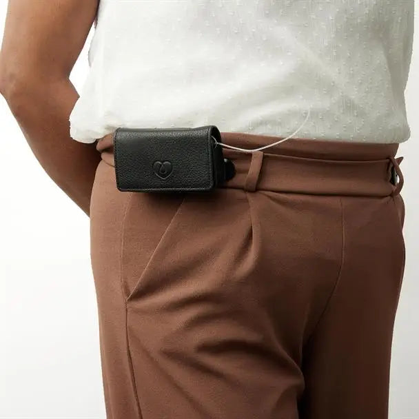 Leather insulin pump bag attached to trousers, showcasing elegant and secure design.