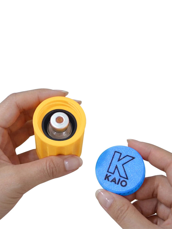 Hands opening Kaio insulin vial protector for standard 10ml insulin vial with yellow body and blue cap