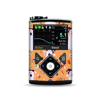 Medtronic MiniMed Insulin Pump with Halloween-themed stickers featuring ghosts and pumpkins.
