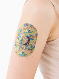 Dexcom G7 adhesive patch, Tequila Sunrise design, on the arm
