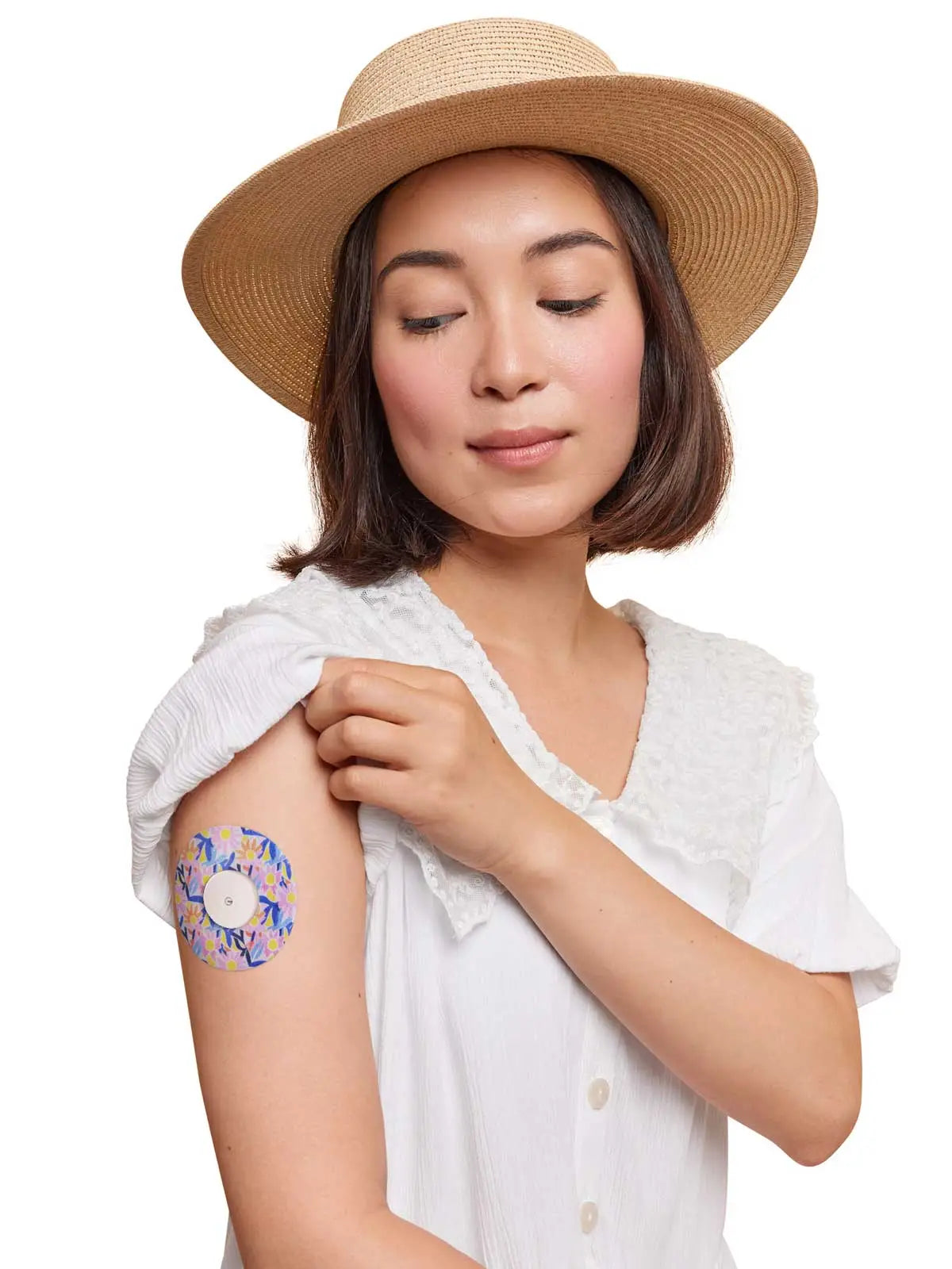 FreeStyle Libre 2 adhesive patch, Spring Series, worn on the arm by a woman
