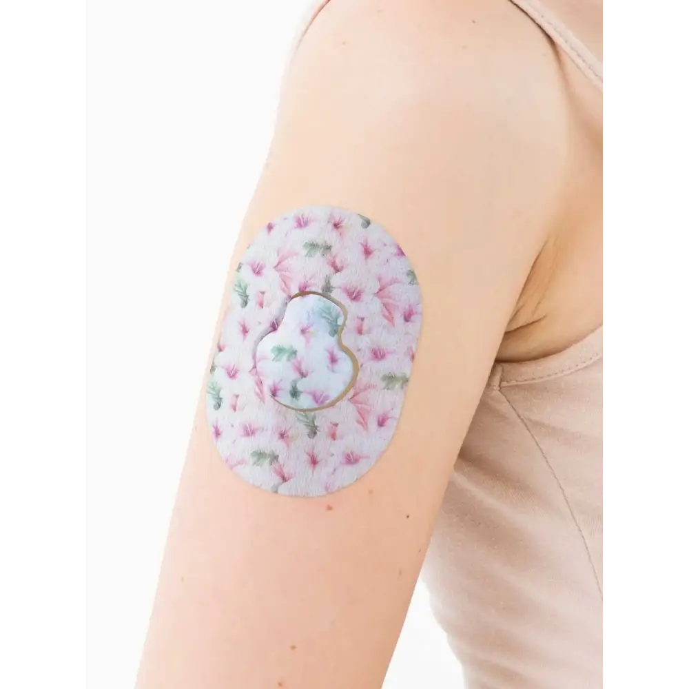 Floral-patterned Guardian Enlite adhesive patches offering secure hold for glucose monitoring