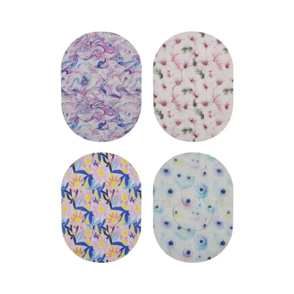 Four Guardian Enlite adhesive patches featuring vibrant patterns for secure hold