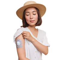 Omnipod pod adhesive patch, Spring Series, worn on the arm by a woman