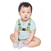 Insulin pump harness for kids in green, worn by a toddler.